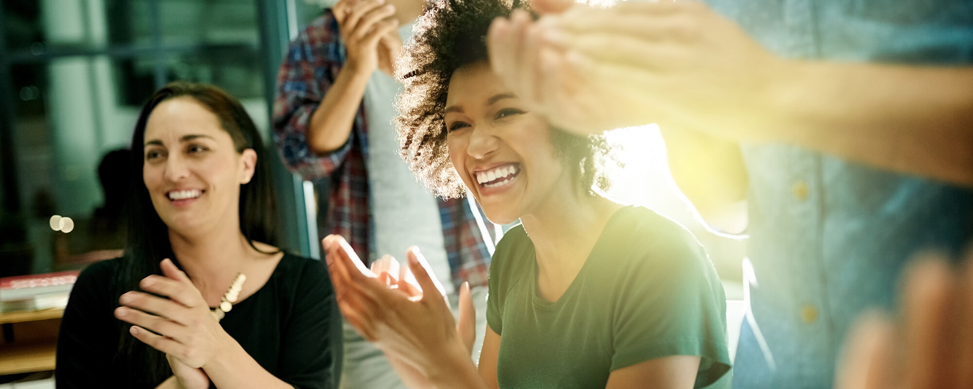 People in a meeting clapping